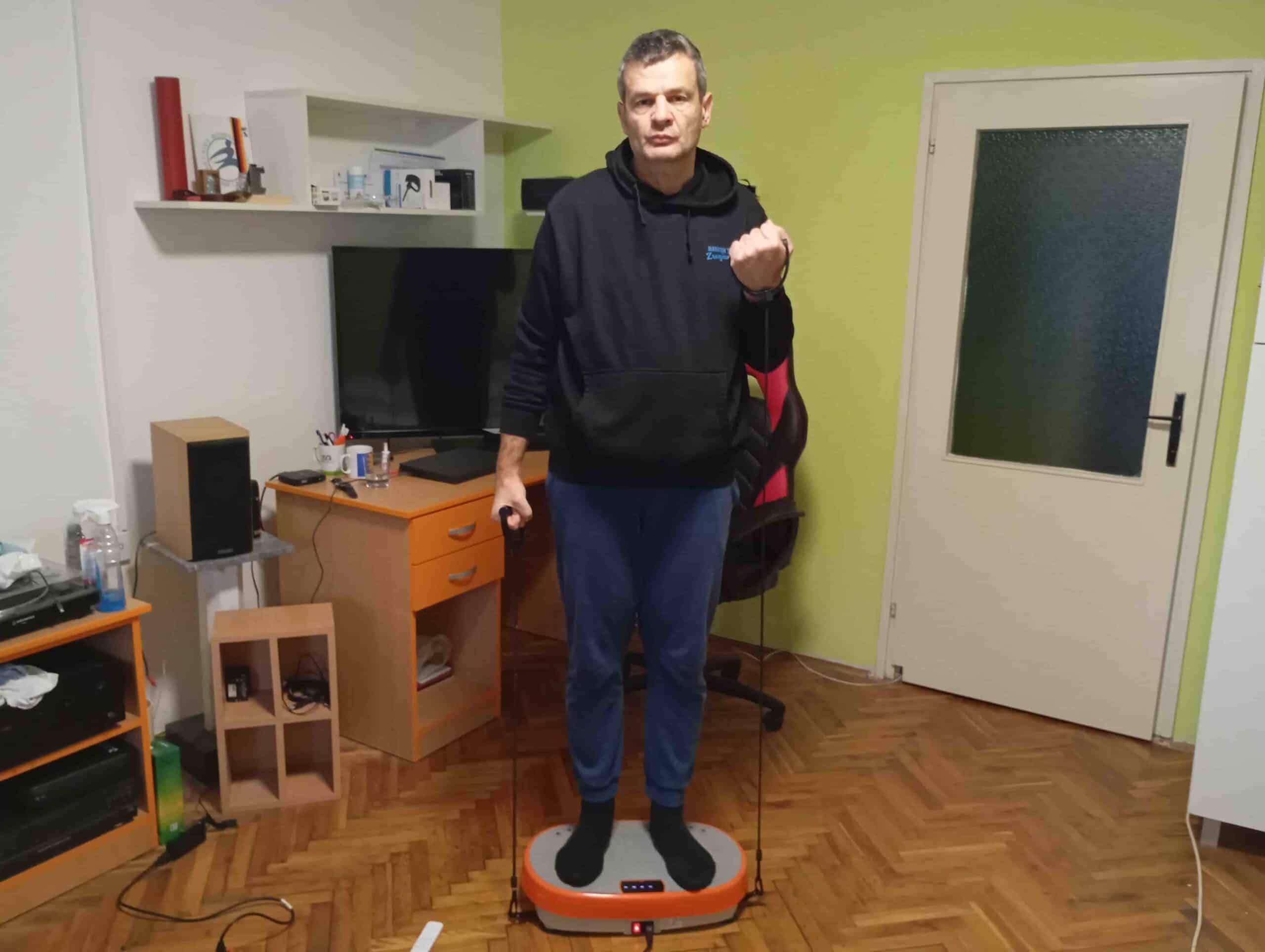 Vladimir Stanar on a vibration plate elastic bands biceps curl left Vladimir Stanar on a vibration plate elastic bands biceps curl left