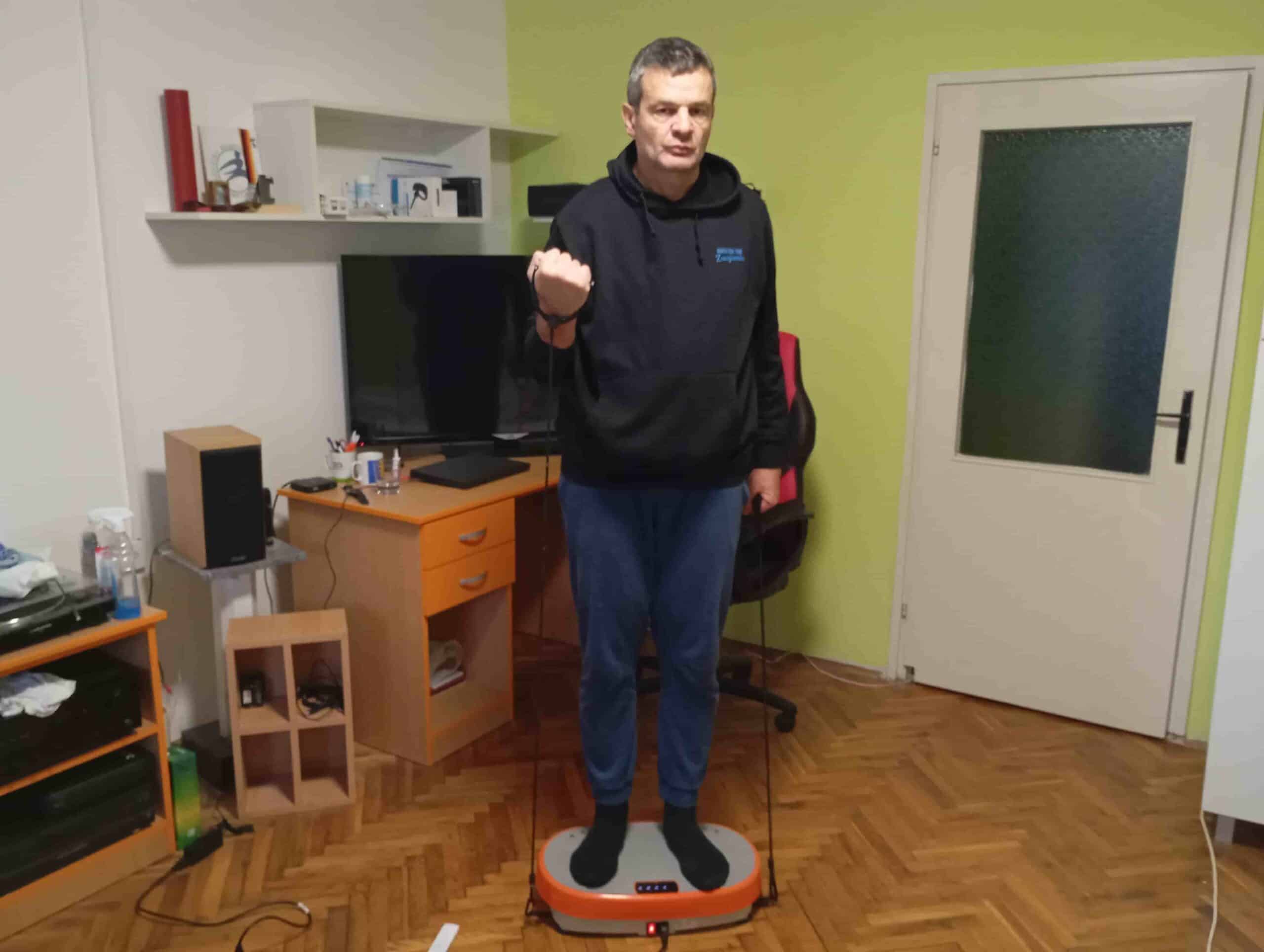 Vladimir Stanar on a vibration plate elastic bands biceps curl right Vladimir Stanar on a vibration plate elastic bands biceps curl right