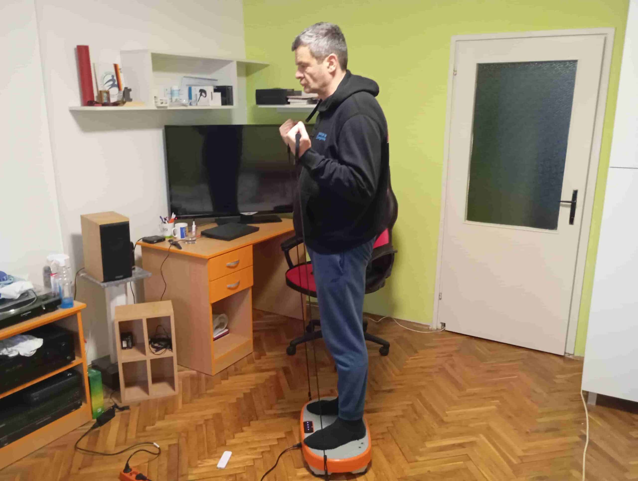 Vladimir Stanar on a vibration plate elastic bands biceps curl side view Vladimir Stanar on a vibration plate elastic bands biceps curl side view