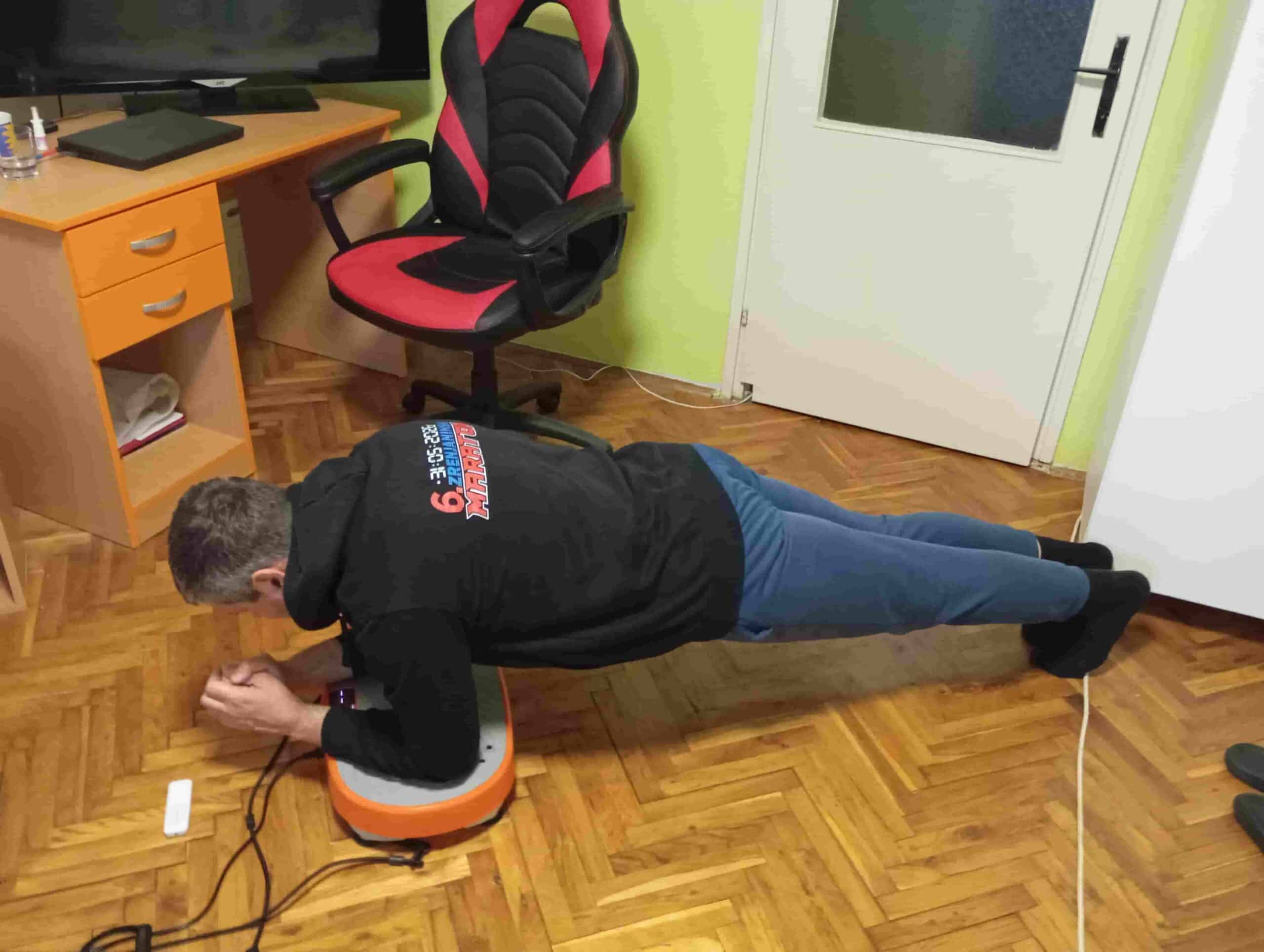 Vladimir Stanar on a vibration plate elbow plank side view Vladimir Stanar on a vibration plate elbow plank side view