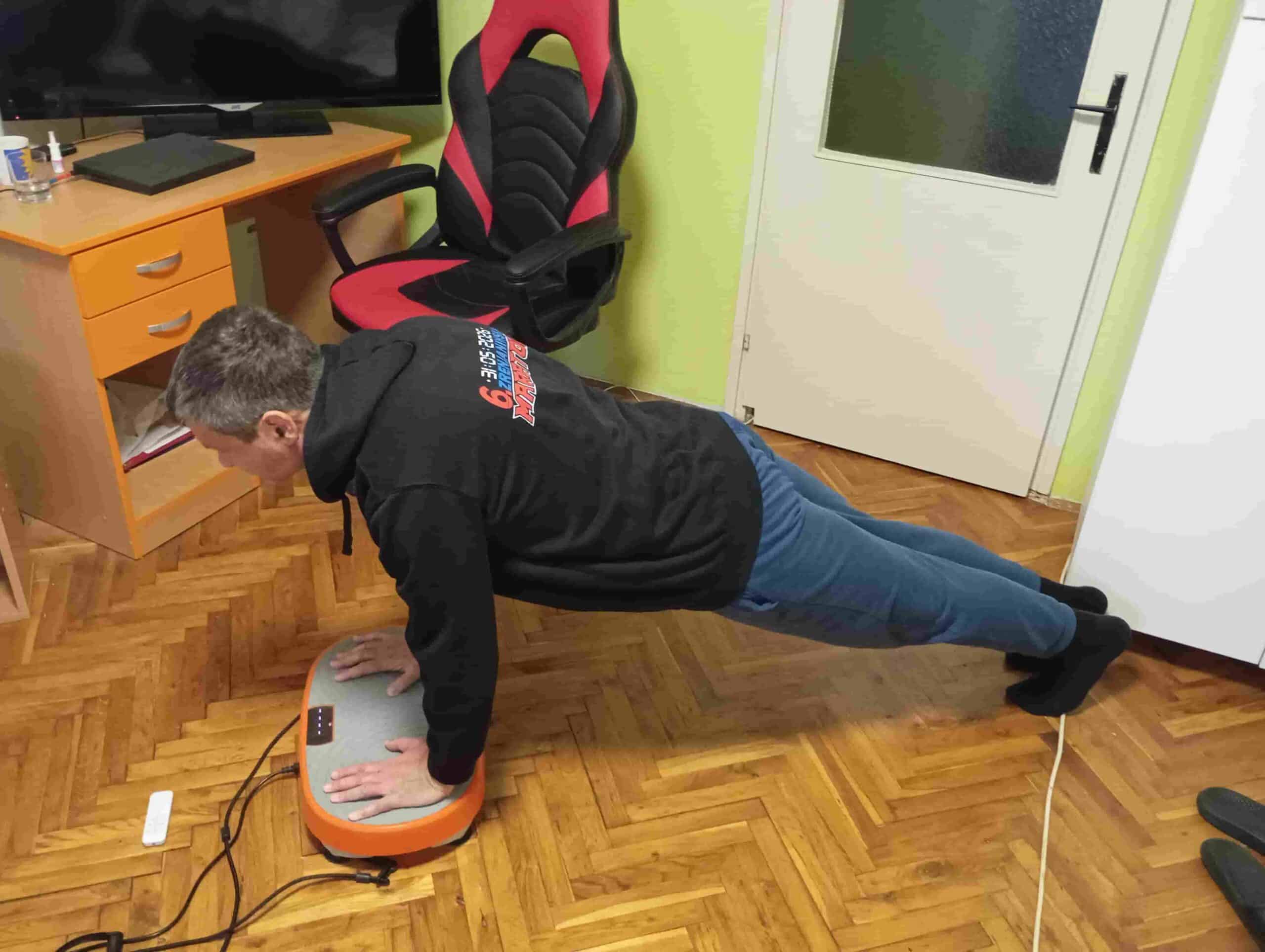 Vladimir Stanar on a vibration plate full plank side view Vladimir Stanar on a vibration plate full plank side view