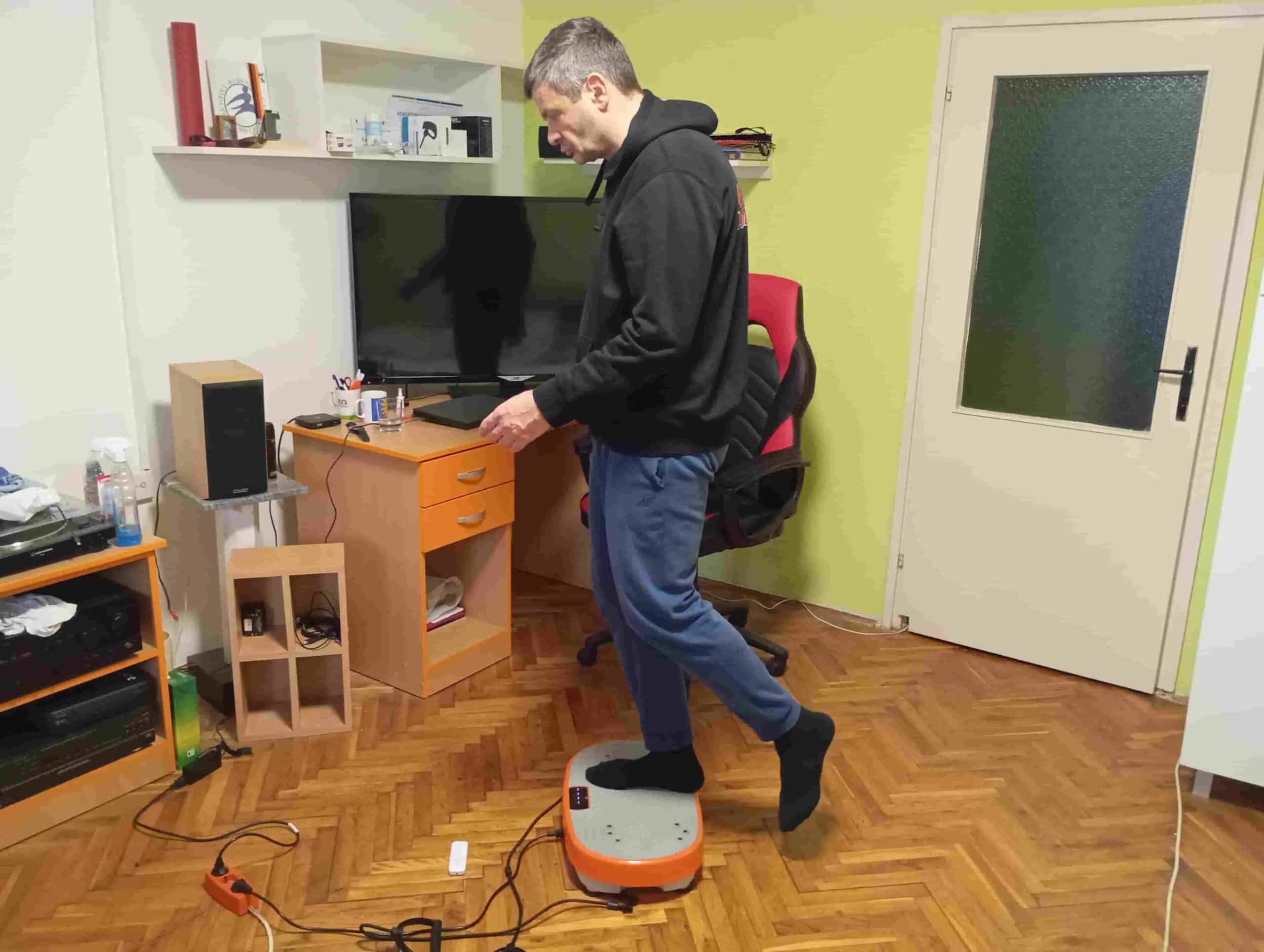 Vladimir Stanar on a vibration plate right leg step on side view Vladimir Stanar on a vibration plate right leg step on side view