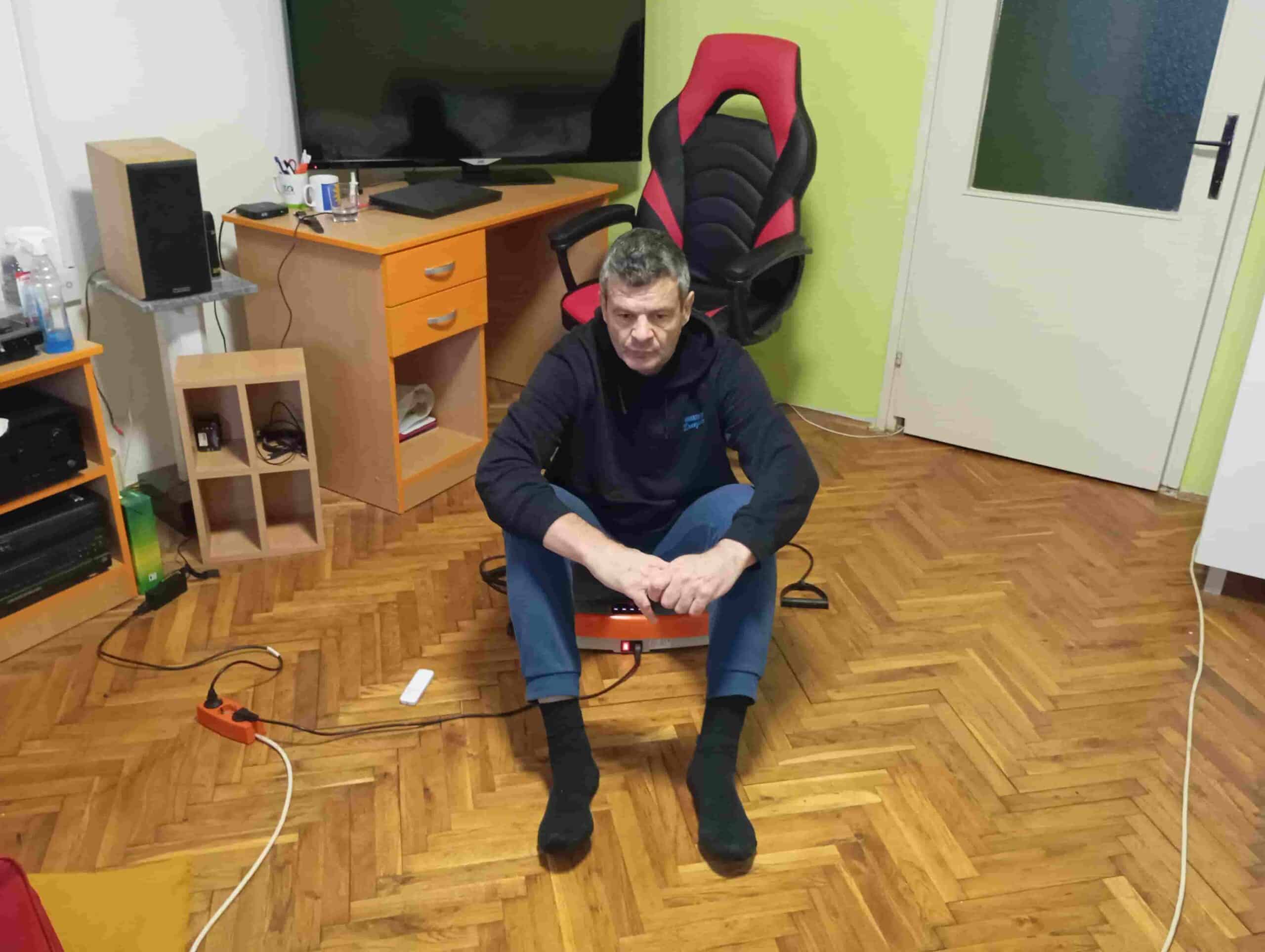 Vladimir Stanar sitting on a vibration plate back and torso relaxed low vibration setting Vladimir Stanar sitting on a vibration plate back and torso relaxed low vibration setting