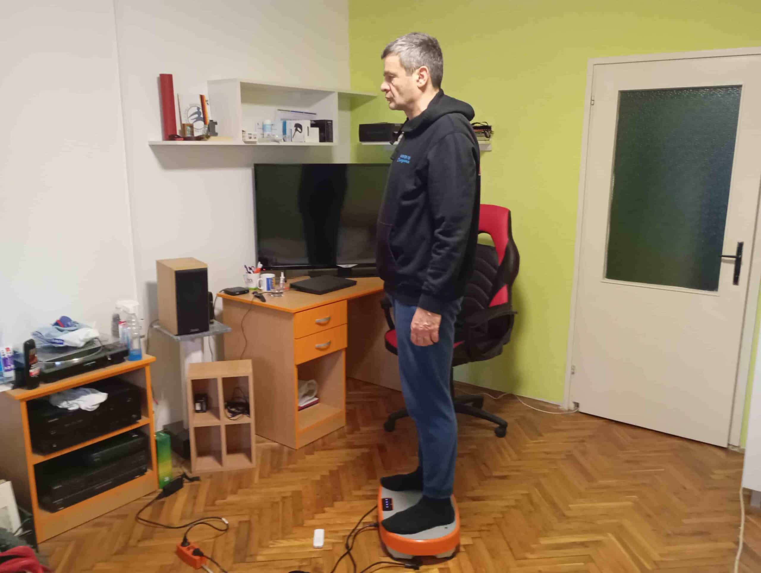 Vladimir Stanar standing on a vibration plate side view Vladimir Stanar standing on a vibration plate side view