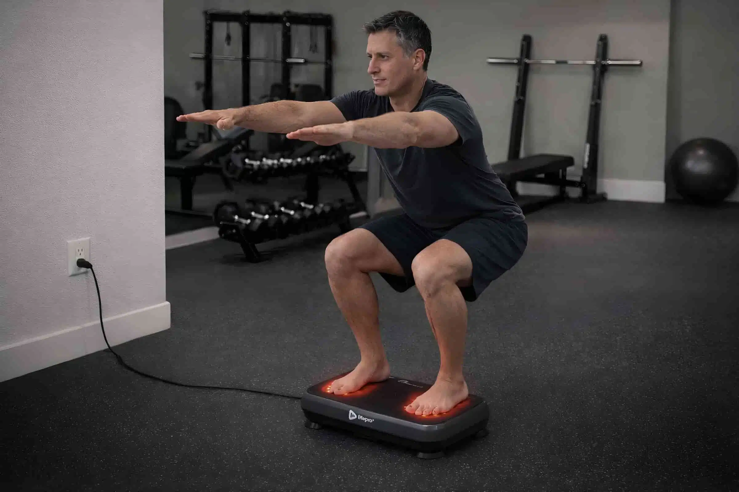 A man doing half squat on the Lifepro VibraRed A man doing half squat on the Lifepro VibraRed