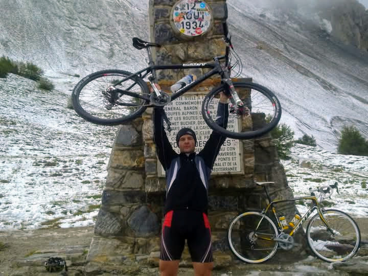 Vladimir holding his bike above his head