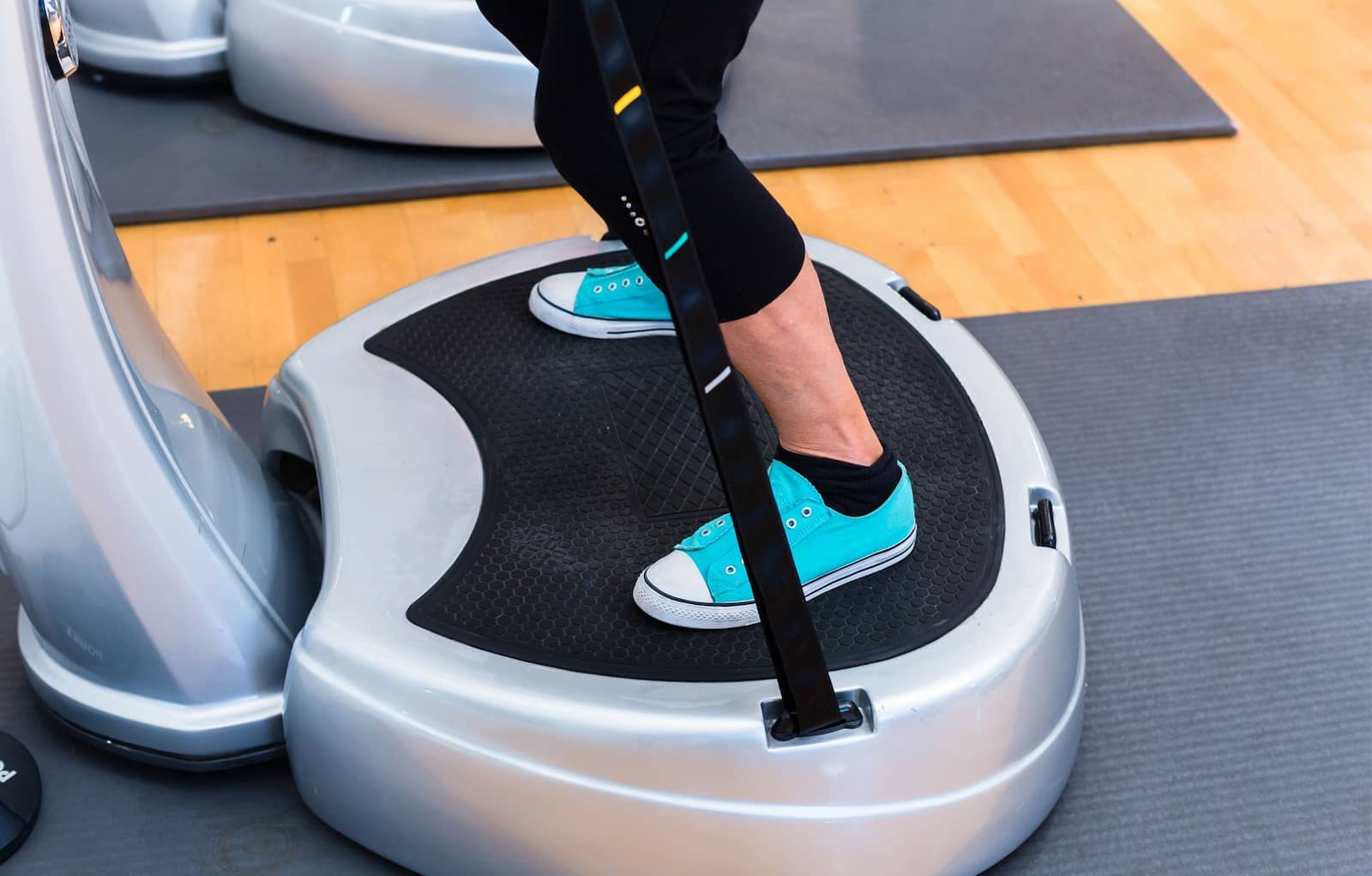 A person using vibration plate in the gym